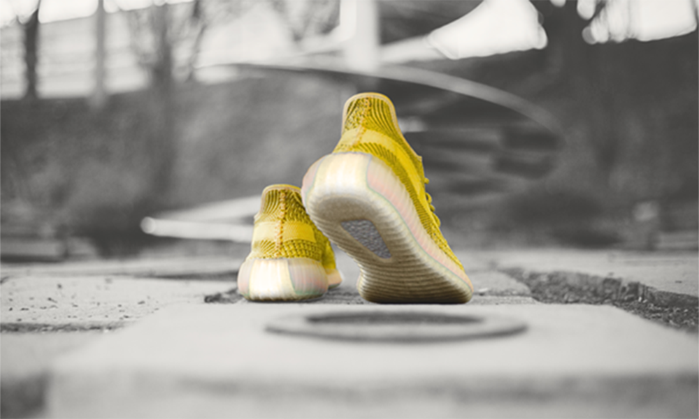 Pair of yellow sneakers on concrete