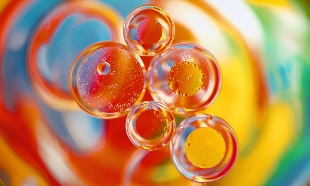 Colorful bubbles representing the excess foam that Momentive’s SagTex™ silicone foam control agents help manage during textile treatments.