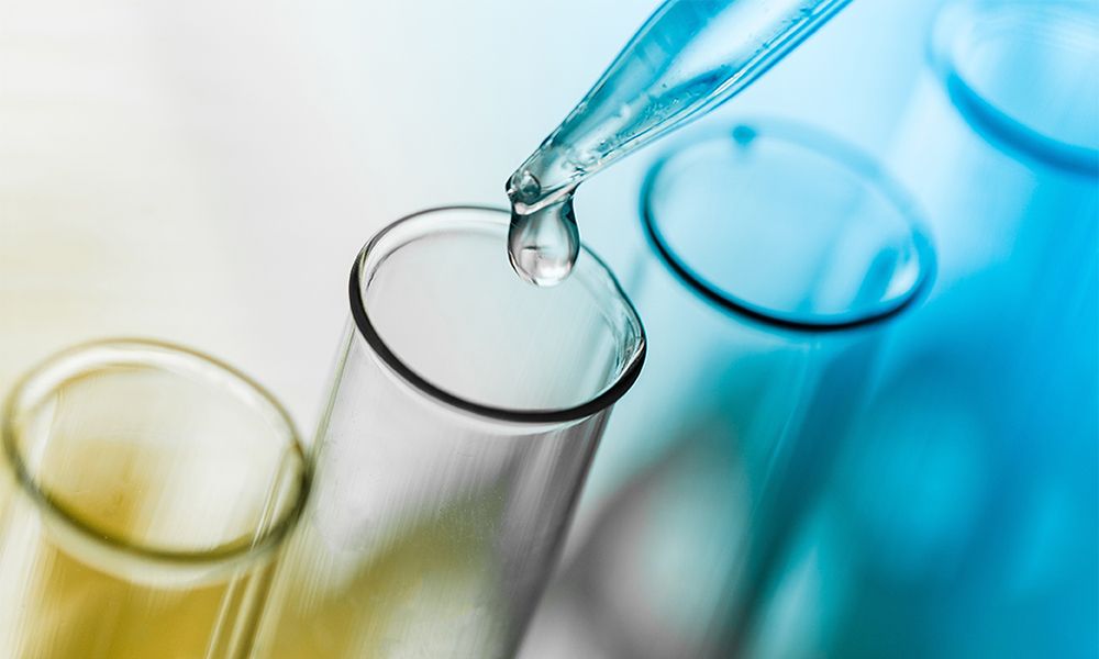 Pipette dispensing liquid into test tube representing special additives for high-performance polyurethane footwear and CASE manufacturing.