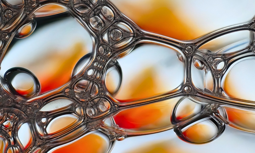 Close-up of silicone surfactant bubbles illustrating solutions for optimized polyurethane molded foam performance.