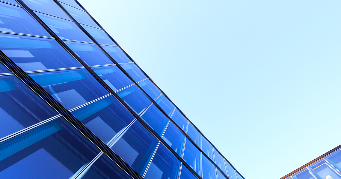 L-shaped glass facade of a modern office building in Hamburg, Germany.