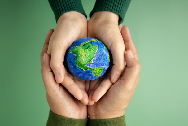 Hands holding a representation of Earth