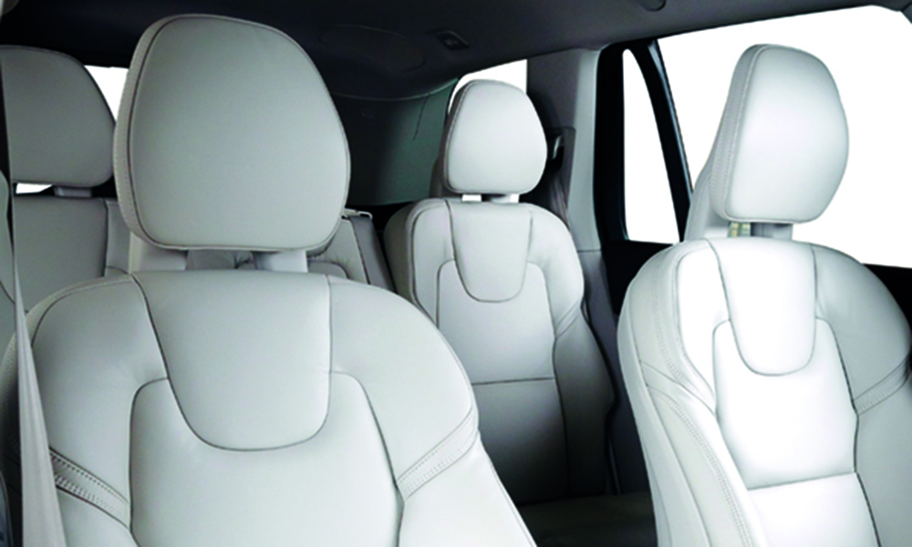 Luxury car inside. Interior of prestige modern car. Comfortable leather seats. White leather cockpit with isolated white background.