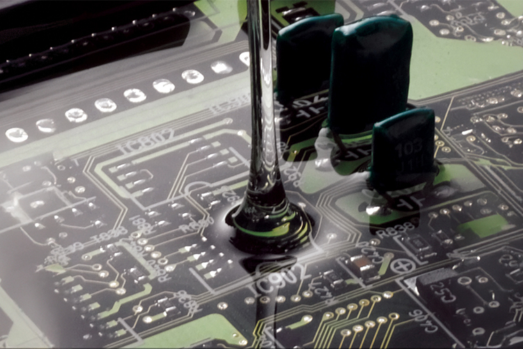 Gel being poured on circuit board